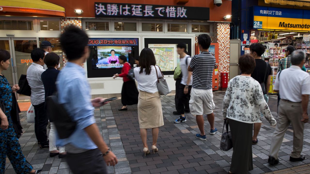 TOKYO, JAPAN - SEPTEMBER 03: Pedestrians watch a monitor showing a news program reporting on North Korea's 6th nuclear test on September 3, 2017 in Tokyo, Japan. South Korea, Japan and the U.S. detected an artificial earthquake from Kilju, northern Hamgyong Province of North Korea. State news agency KCNA announced Pyongyang have successfully carried out a test of a hydrogen bomb, which could be loaded to the Intercontinental Ballistic Missile (ICBM) missile. (Photo by Tomohiro Ohsumi/Getty Images)
