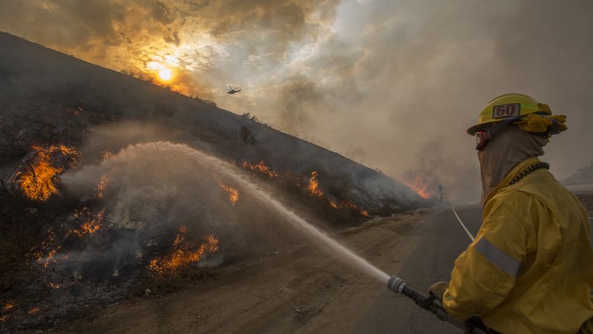 BURBANK, CA - SEPTEMBER 02: Firefighters use hoses and helicopters to fight the La Tuna Fire on September 2, 2017 near Burbank, California. Los Angeles Mayor Eric Garcetti said at a news conference that officials believe the fire, which is at 5,000 acres and growing, is the largest fire ever in L.A. People have been evacuated from hundreds of homes in Sun Valley, Burbank and Glendale. About 100 Los Angles firefighters are expected to return soon from Texas, where they've been helping survivors from Hurricane Harvey.    (Photo by David McNew/Getty Images)