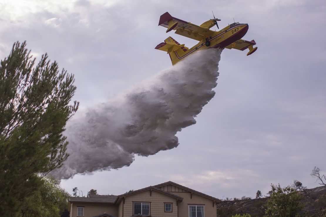 A Super Scooper CL-415 firefighting aircraft from Canada is helping protect homes.