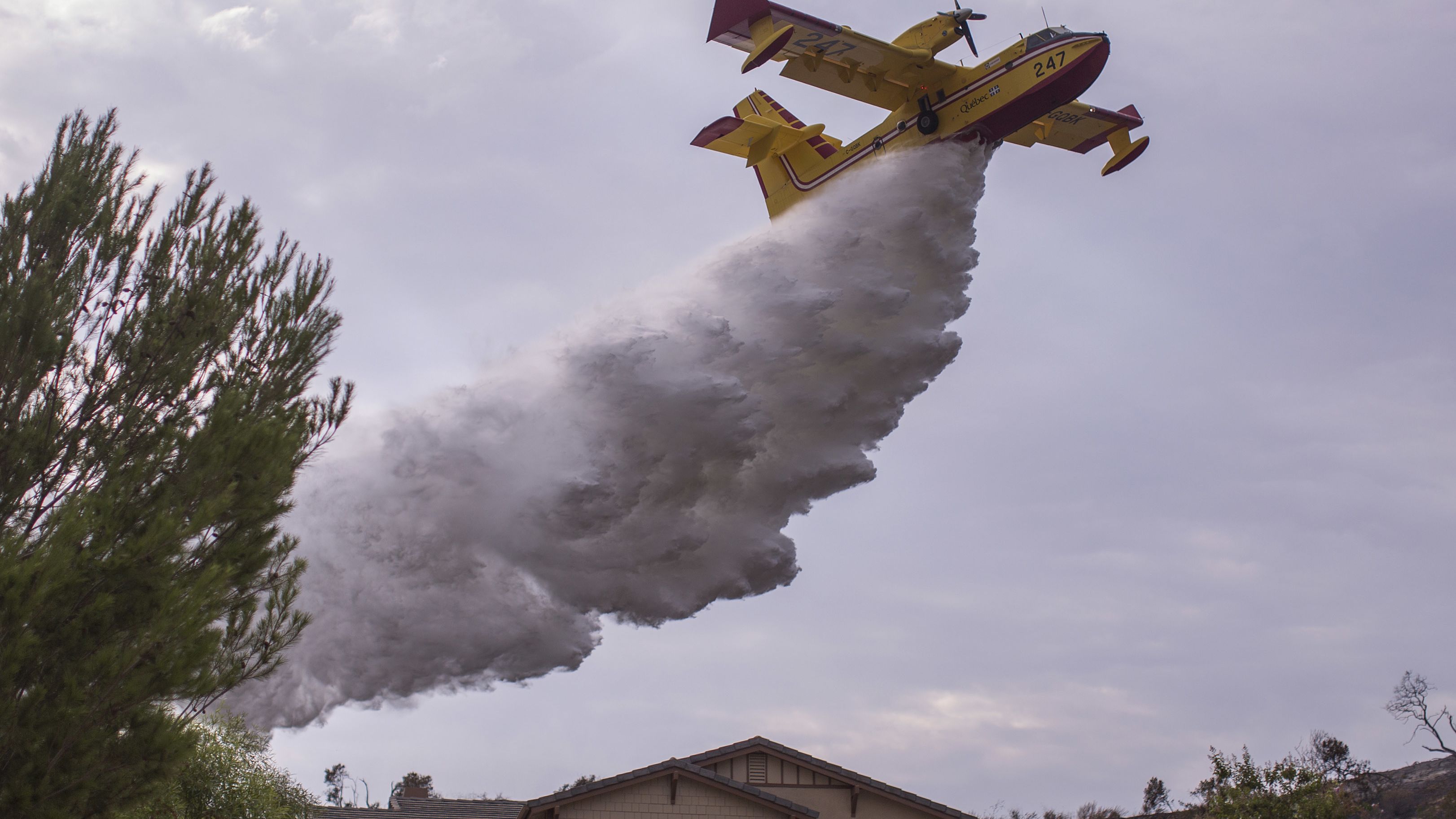 A Super Scooper CL-415 firefighting aircraft from Canada is helping protect homes.