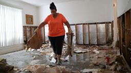 Regina Perry carries damaged drywall out of her home in Houston on September 2.