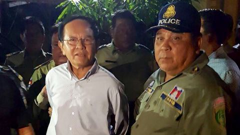 Cambodian opposition leader Kem Sokha is escorted by police at his home in Phnom Penh on September 3, 2017.