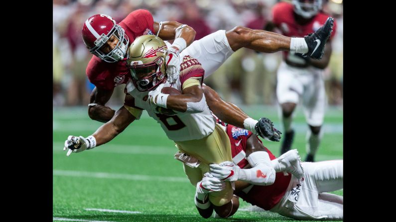 Florida State wide receiver Nyqwan Murray is tackled by Alabama defensive backs Anthony Averett, top, and Shyheim Carter during a college football game in Atlanta on Saturday, September 2. Alabama won 24-7 in what was an opening matchup of two top-ranked teams. Alabama came into the game No. 1 in the country, while Florida State was No. 3.