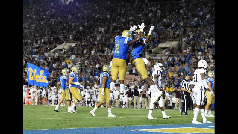 UCLA wide receivers Jordan Lasley, left, and Theo Howard celebrate a fourth-quarter touchdown during the Bruins' <a href="index.php?page=&url=http%3A%2F%2Fbleacherreport.com%2Farticles%2F2731294-josh-rosen-ucla-erase-34-point-deficit-to-shock-texas-am-45-44" target="_blank" target="_blank">spectacular comeback against Texas A&M</a> on Sunday, September 3. UCLA trailed 44-10 with two minutes left in the third quarter, but it rallied to win 45-44. Lasley caught the game-winning touchdown with 43 seconds left.