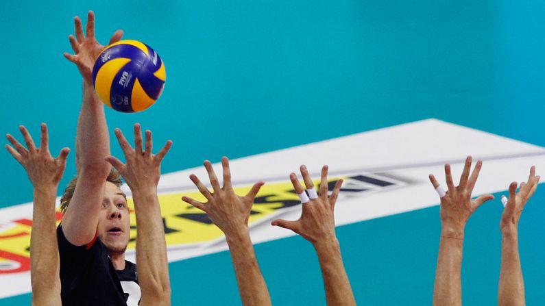 Belgium's Sam Deroo tries to spike the ball past Serbian blockers on Sunday, September 3. It was the third-place game at the European Volleyball Championship, and Serbia won in five sets. Russia won the tournament for the 14th time.