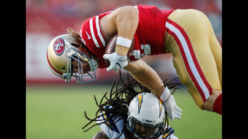 San Francisco tight end Logan Paulsen is tackled by Los Angeles Chargers cornerback Brandon Stewart during an NFL preseason game on Thursday, August 31.
