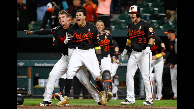 The Baltimore Orioles celebrate after Jonathan Schoop, not pictured, hit a walk-off double to beat Toronto in the 13th inning on Friday, September 1.