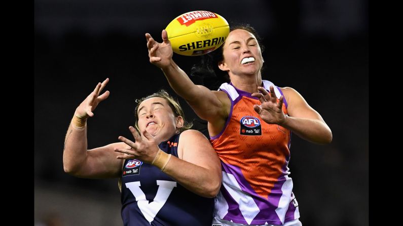 Sarah Perkins, left, and Leah Kaslar compete for a ball during an Australian rules football match in Melbourne on Saturday, September 2. Perkins' Victoria team defeated Kaslar's Allies by 97 points.
