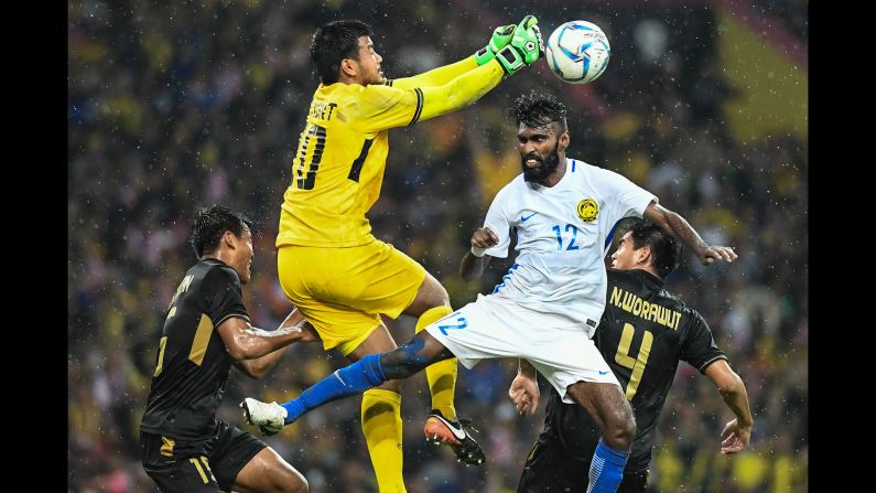 Thai goalkeeper Nont Muangngam punches the ball past Malaysia's Thanabalan Nadarajah during the final of the Southeast Asian Games on Tuesday, August 29. Thailand won 1-0.