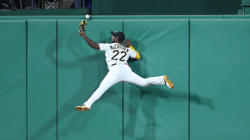 Pittsburgh center fielder Andrew McCutchen leaps into the wall but can't make the catch during a game against Cincinnati on Friday, September 1.