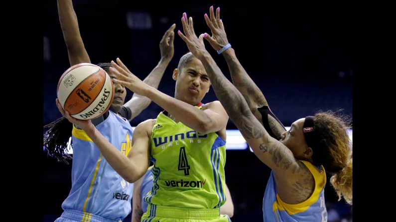 Dallas guard Skylar Diggins-Smith looks to pass as she's guarded by Chicago's Jessica Breland, left, and Cappie Pondexter during a WNBA game on Wednesday, August 30.