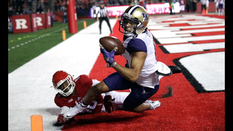 Washington wide receiver Dante Pettis pulls in a pass as he's defended by Rutgers cornerback Blessuan Austin during a college football game in Piscataway, New Jersey, on Friday, September 1. Pettis was ruled out of bounds on the play.
