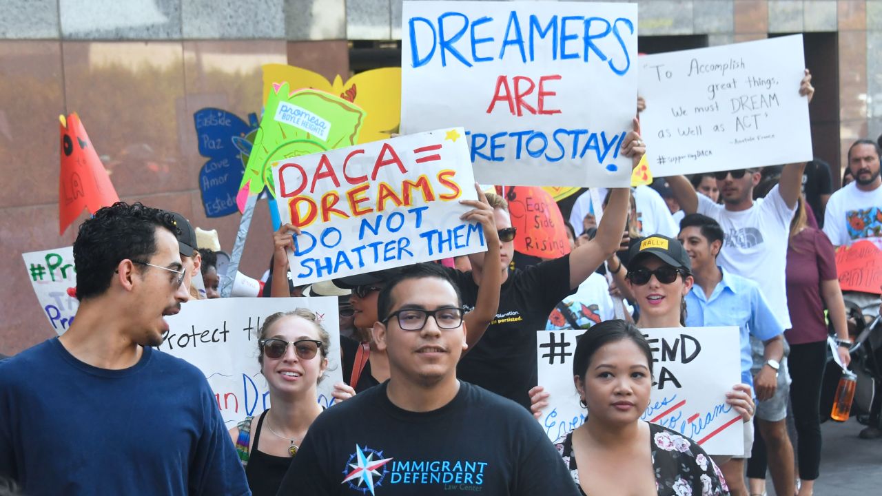 Young immigrants and supporters walk holding signs during a rally in support of Deferred Action for Childhood Arrivals (DACA) in Los Angeles, California on September 1, 2017.
A decision is expected in coming days on whether US President Trump will end the program by his predecessor, former President Obama, on DACA which has protected some 800,000 undocumented immigrants, also known as Dreamers, since 2012. / AFP PHOTO / FREDERIC J. BROWN        (Photo credit should read FREDERIC J. BROWN/AFP/Getty Images)