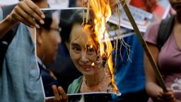 Activists of an ultra-leftist organization burn a poster featuring a photograph of Myanmar's State Counsellor Aung San Suu Kyi during a protest against the persecution of Rohingya Muslims near Myanmar Consulate in Kolkata, India, Monday, Sept. 4, 2017. Protestors demand postponement of proposed visit of Indian Prime Minister Narendra Modi to Myanmar. At least 87,000 refugees from Myanmar's western Rakhine state have fled to neighboring Bangladesh since violence escalated in late August, according to the United Nations. (AP Photo/Bikas Das)