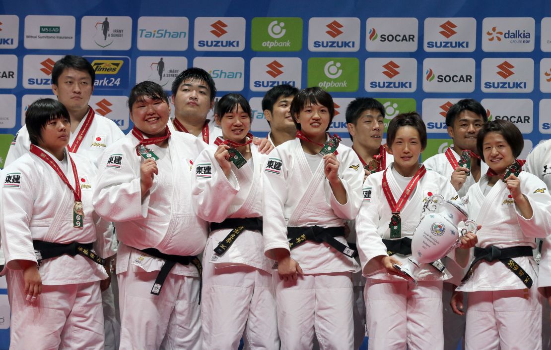 Japanese judoka celebrate winning Sunday's team event at the World Judo Championships