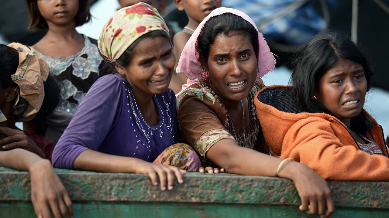 Rohingya migrant women cry as they sit on a boat drifting in Thai waters off the southern island of Koh Lipe in the Andaman sea on May 14, 2015. The boat crammed with scores of Rohingya migrants -- including many young children -- was found drifting in Thai waters on May 14, according to an AFP reporter at the scene, with passengers saying several people had died over the last few days. AFP PHOTO / Christophe ARCHAMBAULT (Photo credit should read CHRISTOPHE ARCHAMBAULT/AFP/Getty Images)
