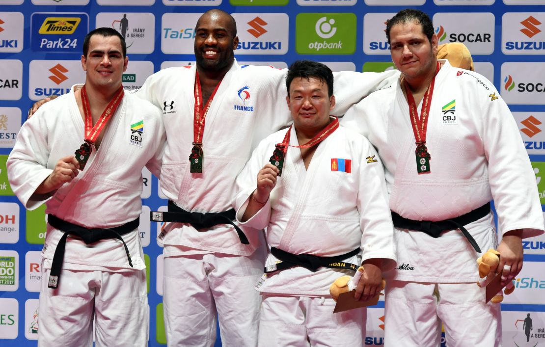 Mongolia's Tuvshinbayar Naidan poses on the podium alongside David Moura, Teddy Riner and Rafael Silva. 