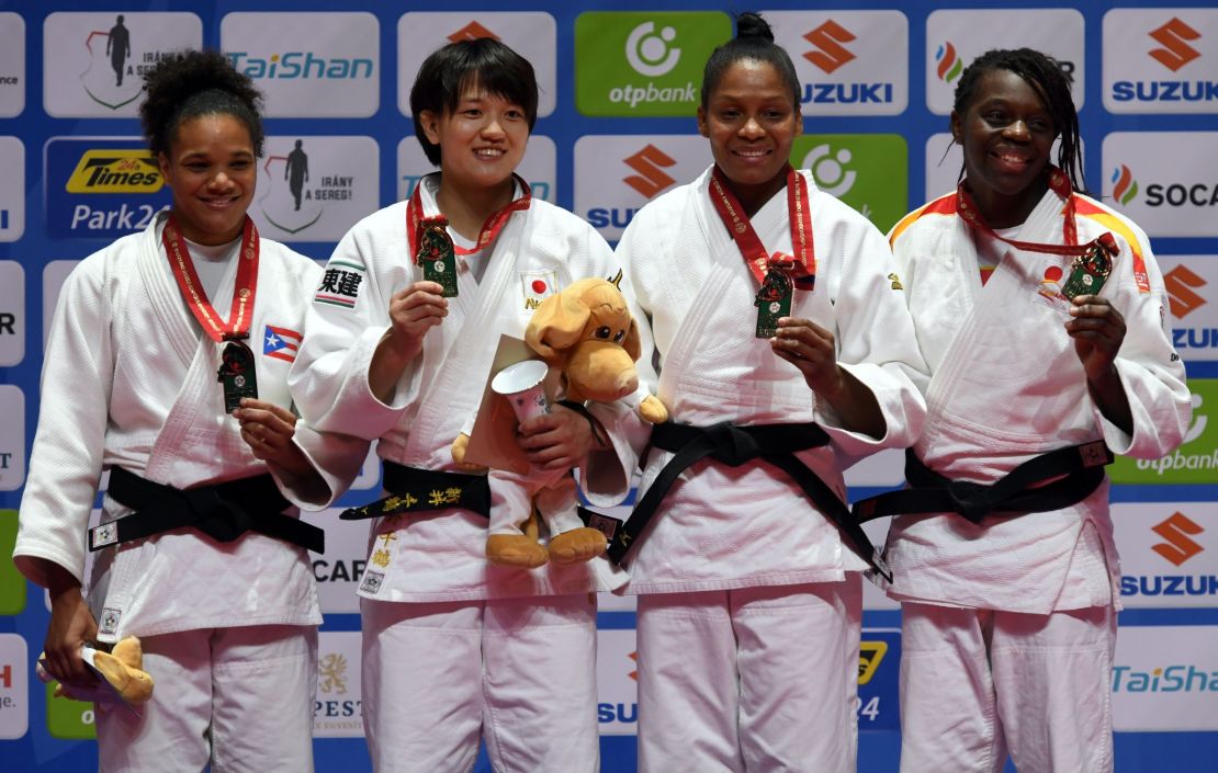 Women's middleweight judoka Maria Perez  (L) celebrates winning Puerto Rico's first ever silver medal.  Japan's Chizuru Arai, Colombia's Yuri Alvear and Spain's Maria Bernabeu join her on the podium.