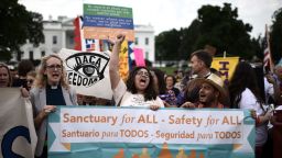 Immigrants and supporters demonstrate holding signs during a rally in support of the Deferred Action for Childhood Arrivals (DACA) in front of the White House in Washington DC on September 5.