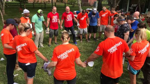 Samaritan's Purse volunteers and a local church group hold hands in prayer in Pearland, Texas.