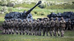 Soldiers from the parade in front of military equiptment as Britain's Queen Elizabeth II (unseen) reviews the Royal Regiment of Artillery at Knighton Down, Larkhill on Salisbury plain, southern England on May 26, 2016.
2016 marks the Tercentenary of the formation of the Royal Artillery when, on 26 May 1716, by Royal Warrant of King George 1, two companies of artillery were formed at Woolwich in London, alongside the guns, powder and shot located in the Royal Arsenal. / AFP / RICHARD POHLE        (Photo credit should read RICHARD POHLE/AFP/Getty Images)