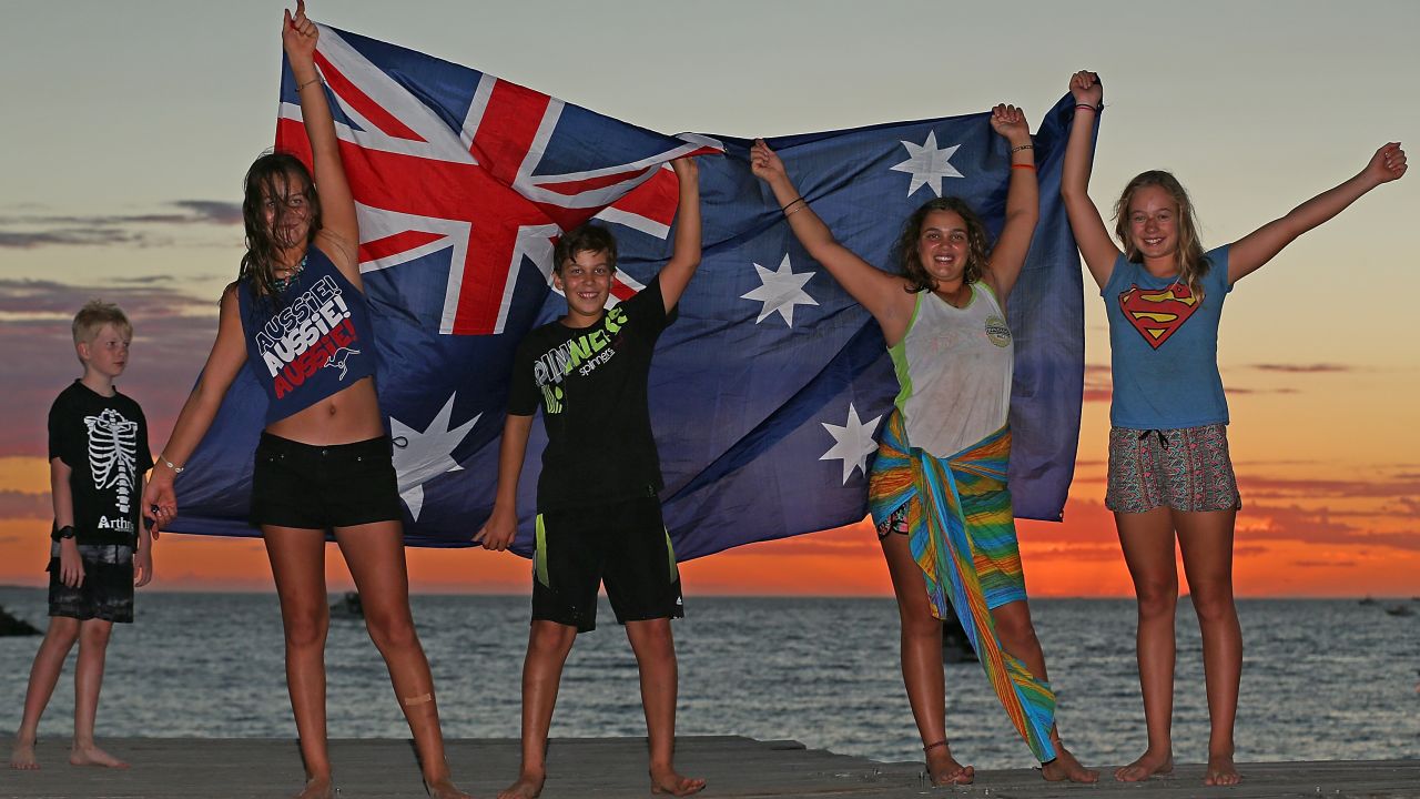 Children display an Australian flag at Bathers Beach on Australia Day, 2017.