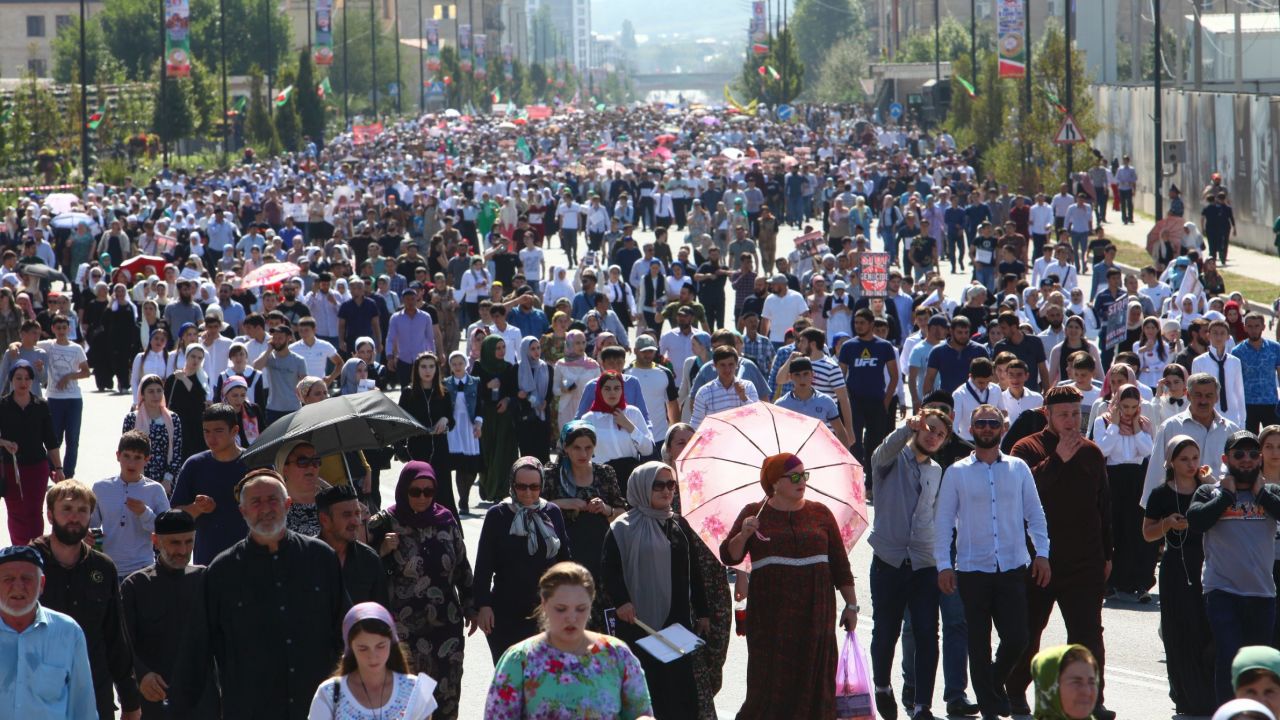 Local residents walk to attend a mass protest in Chechnya's provincial capital Grozny, Russia, Monday, Sept. 4, 2017. Tens of thousands of people have taken to the streets in Russia's predominantly Muslim Chechnya to protest what the Chechen leader called "genocide of Muslims" in Myanmar. (AP Photo/Musa Sadulayev)