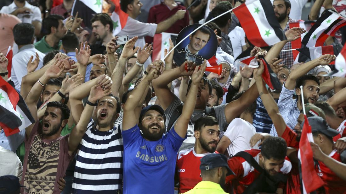 Syria fans celebrate at the end of the match in Tehran.