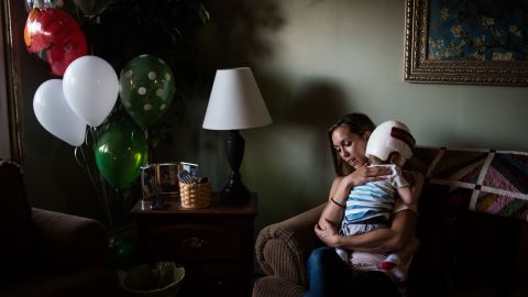 Nicole McDonald comforts her crying son, Jadon, who was frightened by the family dog.