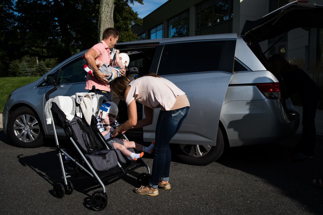Christian and Nicole McDonald load their twins, Jadon and Anias, into the family van as they head home from rehab for the first time.