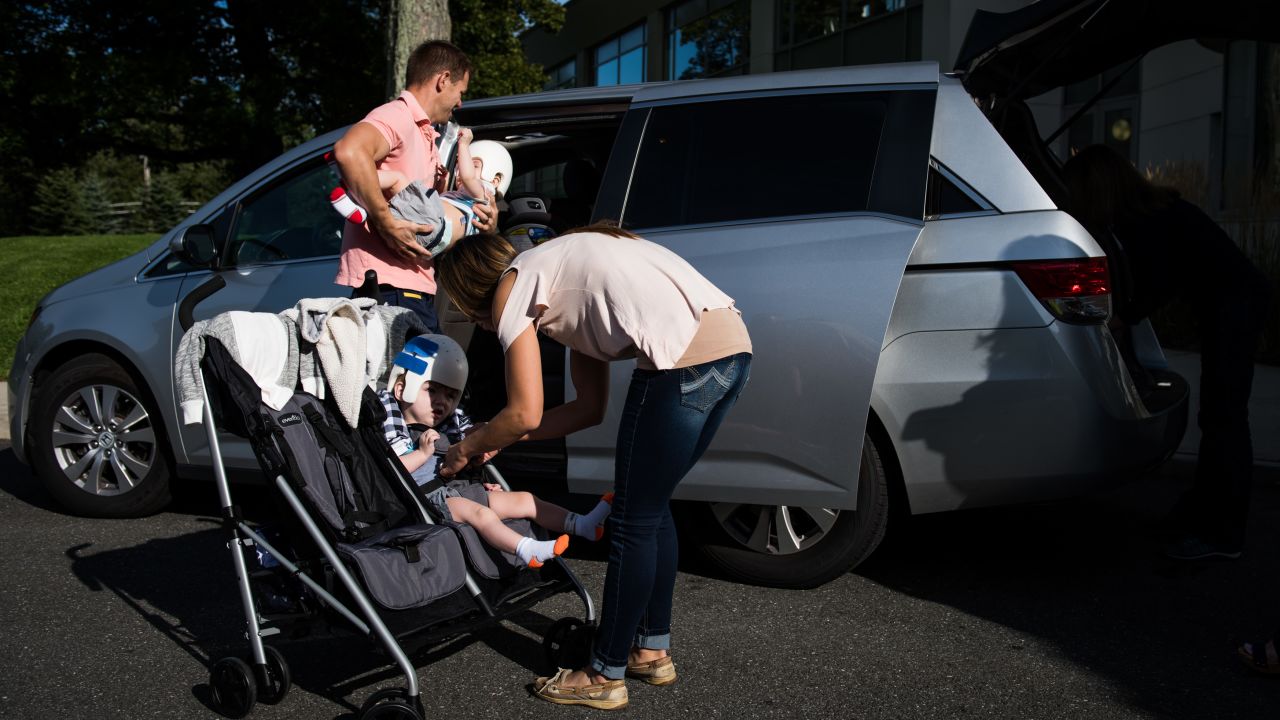 Christian and Nicole McDonald load their twins, Jadon and Anias, into the family van as they head home from rehab for the first time.
