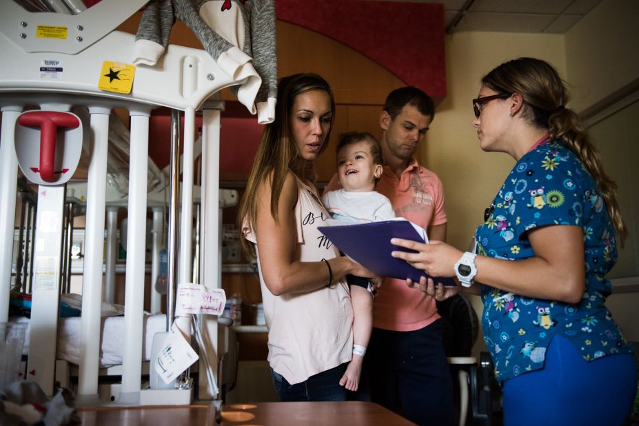 Nicole McDonald holds Jadon while looking over discharge information on September 1, as they prepare to leave the rehab facility and head home as a family for the first time.