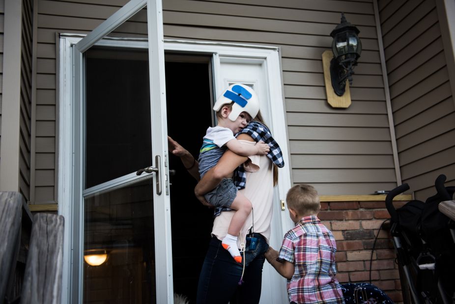 Nicole McDonald takes Anias into the family's new house for the first time with his older brother, Aza.