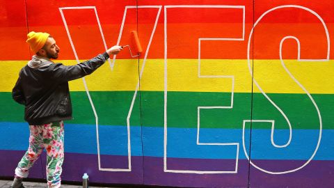 Artist David Lee Pereira paints a pro-gay marriage mural on a wall at Melbourne Central on August 27.