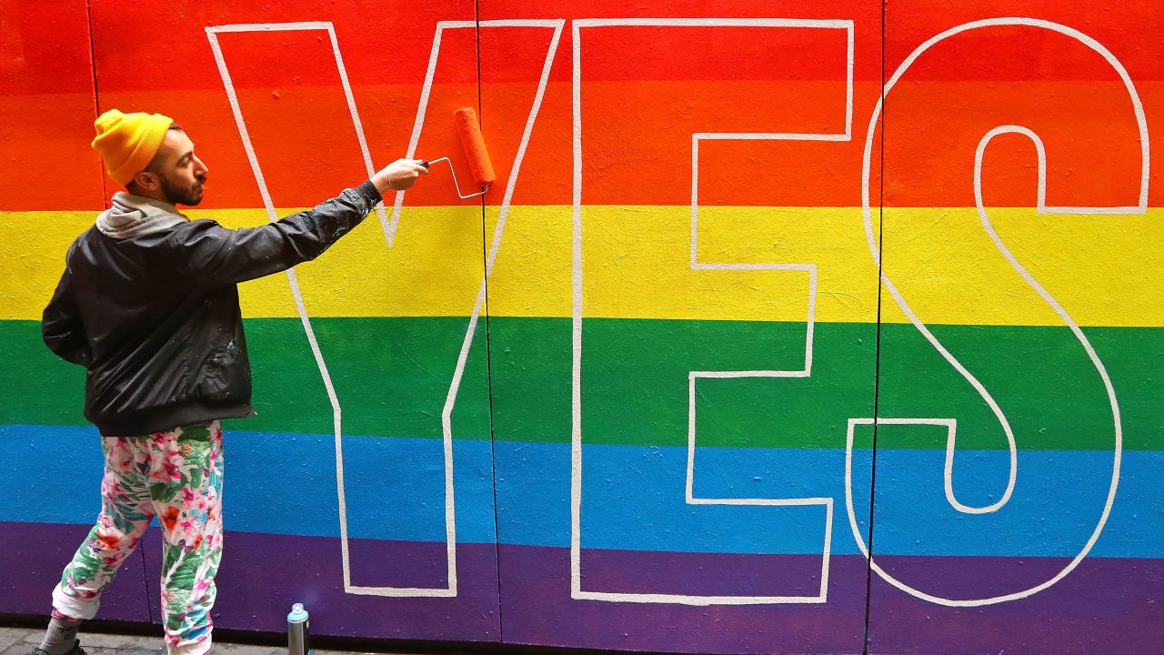 Artist David Lee Pereira paints a pro-gay marriage mural on a wall at Melbourne Central on August 27.