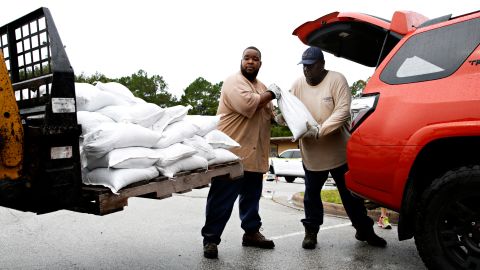 Aut Smith, 42, and Willie Young, 52, load up sandbags for the community at the City of Gainesville Public Works Department, on September 6, in Gainesville, Florida.