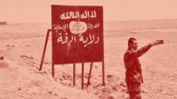 A picture taken on July 9, 2017 shows a Syrian regime forces member taking a selfie with an Islamic State (IS) group billboard at the Ithraya-Rasafa highway in the countryside of the city of Raqa. On June 30, 2017 a  military source, quoted by Syrian state news agency SANA, confirmed that the Islamic State (IS) group had pulled out of territory along the Ithraya-Rasafa highway.  / AFP PHOTO / George OURFALIAN        (Photo credit should read GEORGE OURFALIAN/AFP/Getty Images)