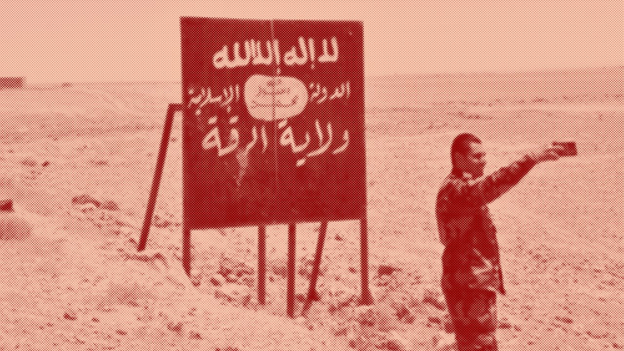 A Syrian regime soldier takes a selfie in front of an ISIS billboard on the side of Ithriya-Rasafa highway, outside of Raqqa city, in July. 