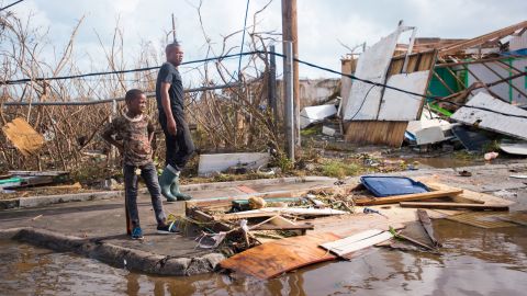 A man and a boy take a look at the damage Irma brought on September 7, in Marigot, near the Bay of Nettle, on the island of St. Martin.