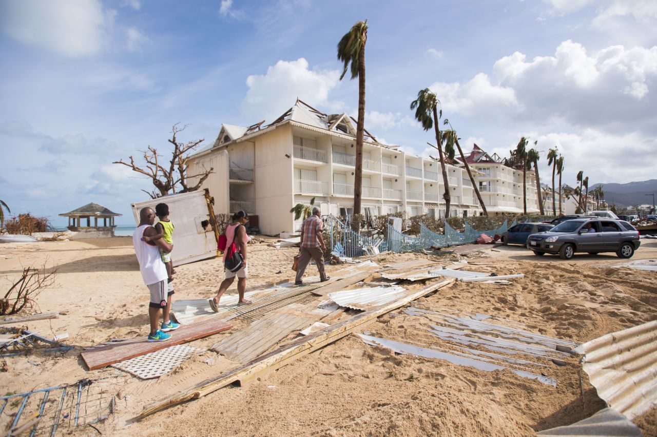 People walk through damage in Marigot, St. Martin, on September 7.