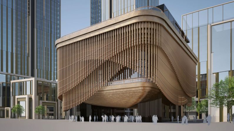 A collaboration between British architectural giants Heatherwick Studio and Foster + Partners, the theater's layers of bronze piping slowly move to reveal glimpses of glass windows and the second floor's golden balcony.