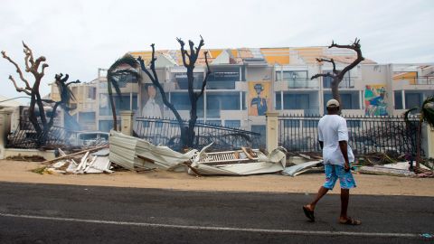 A man walks past damaged buildings in St. Martin on September 6.