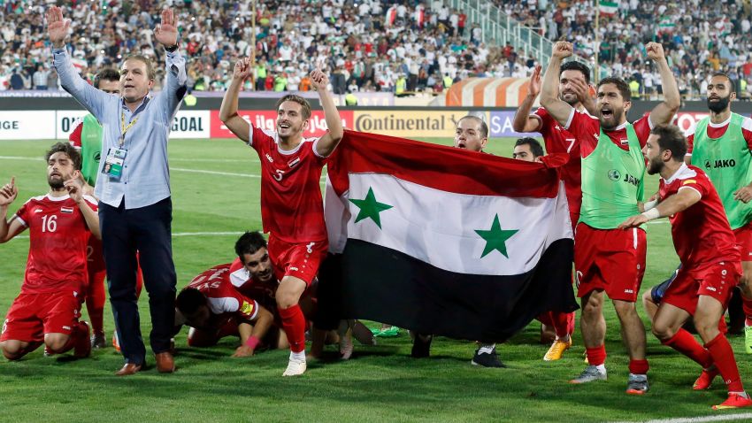 TOPSHOT - Syria's players celebrate at the end of their FIFA World Cup 2018 qualification football match against Iran at the Azadi Stadium in Tehran on September 5, 2017. / AFP PHOTO / ATTA KENARE        (Photo credit should read ATTA KENARE/AFP/Getty Images)
