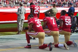 Colin Kaepernick, safety Eric Reid #35, and linebacker Eli Harold #58 of the San Francisco 49ers kneel before a game in November 2016. 