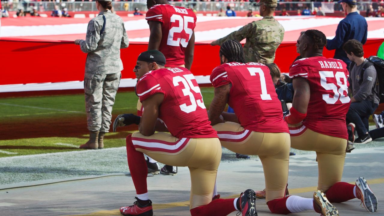 Colin Kaepernick, safety Eric Reid #35, and linebacker Eli Harold #58 of the San Francisco 49ers kneel before a game in November 2016.