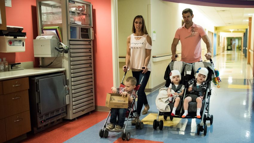 Christian and Nicole McDonald wheel their their twins Jadon and Anias, and oldest son Aza in strollers as they leave their rehab facility at Blythedale Children's Hospital in Valhalla, NY and head home for the first time on September 1, 2017. Credit: Mark Kauzlarich for CNN
