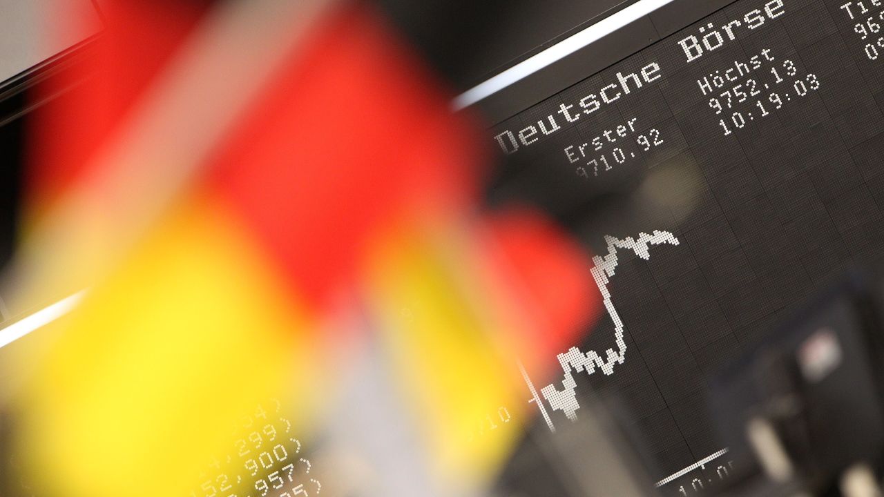 German flags are pictured in front of a display showing the German stock market index DAX at the stock exchange in Frankfurt, Germany, on July 14, 2014. AFP PHOTO / DANIEL ROLAND        (Photo credit should read DANIEL ROLAND/AFP/Getty Images)