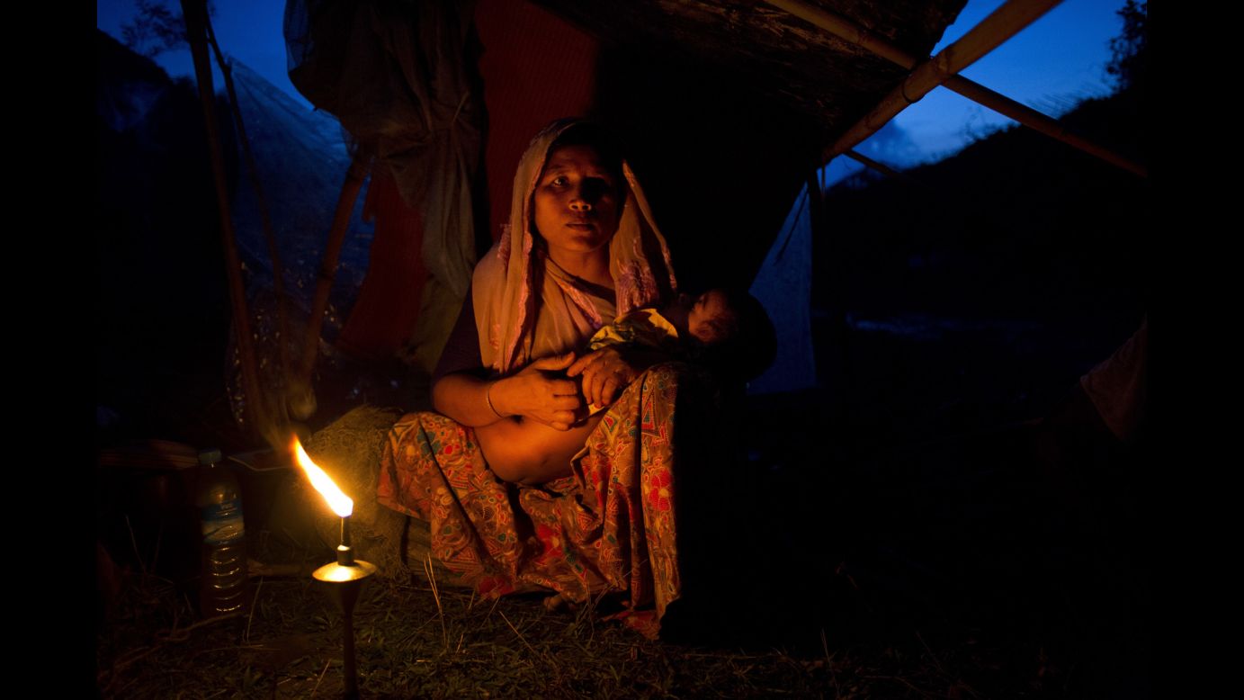 A Rohingya woman from Myanmar cradles her child at a temporary camp in Bangladesh on Saturday, September 2. More than 120,000 Rohingya <a href="http://www.cnn.com/2017/09/05/asia/rohingya-mass-protest-report/index.html" target="_blank">have fled to Bangladesh</a> to escape violence in their native Rakhine State, according to a United Nations official in Bangladesh.