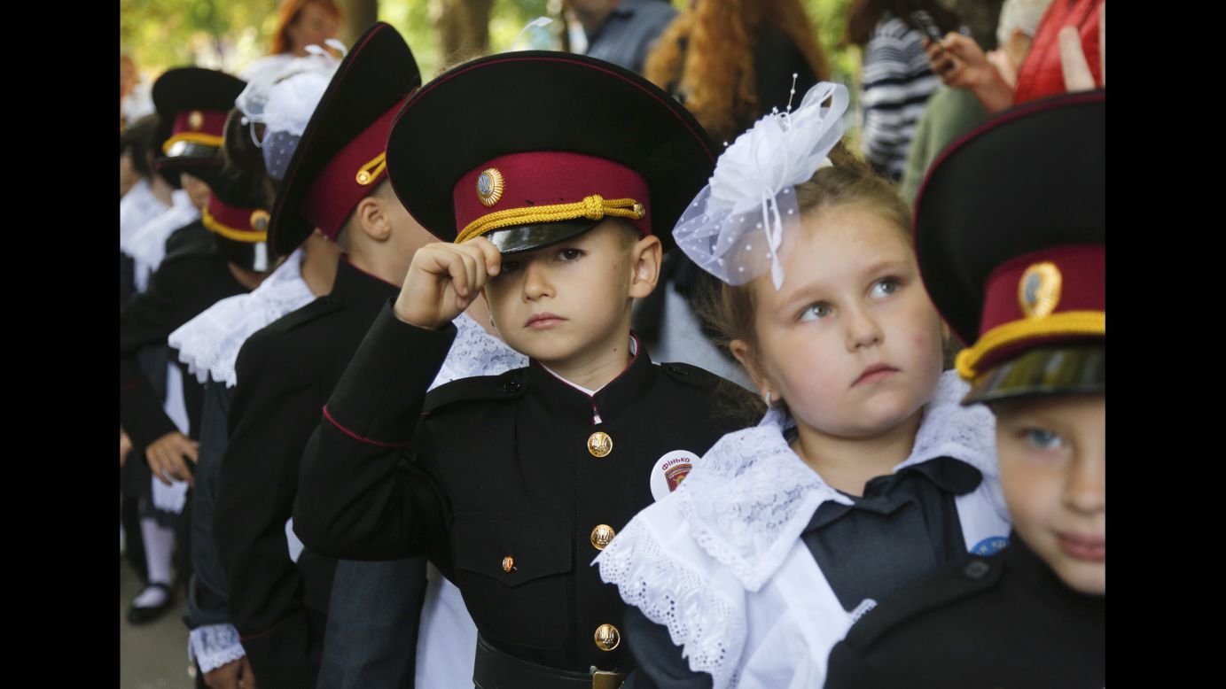 Young cadets and schoolgirls attend a ceremony on the first day of school in Kiev, Ukraine, on Friday, September 1.