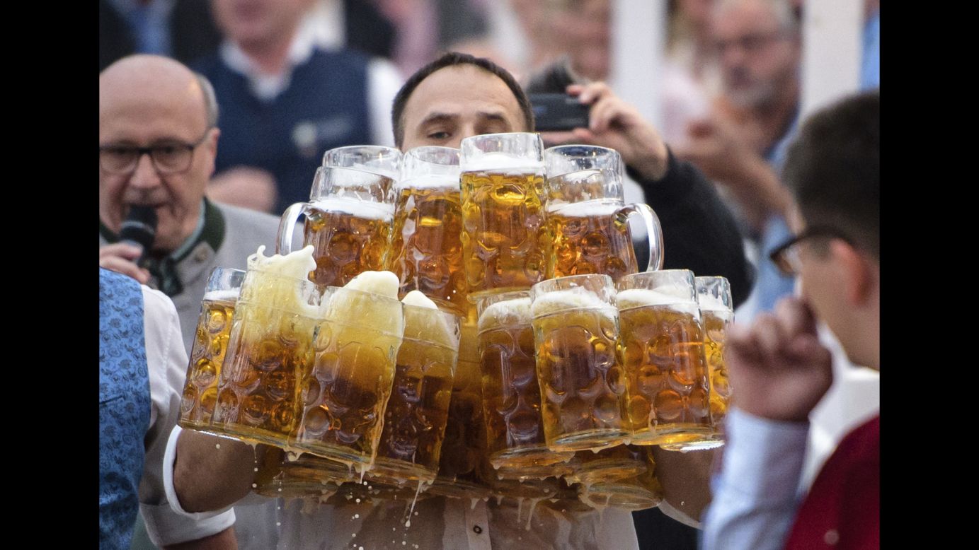 Oliver Strumpfel carries 31 steins of beer Sunday, September 3, as he attempts to set a new world record in Abensberg, Germany. He dropped one and lost too much beer in another, but the final tally of 29 was still a new record for carrying beer over 40 meters (131 feet). He also held the previous record of 25.